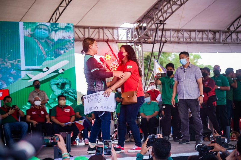 Vice-Presidential candidate Sara Duterte hugs a supporter on stage during an election campaign event in Balayan City, Batangas. (Picture: Yummie Dingding)